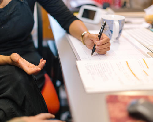 A woman making notes in a clinical setting