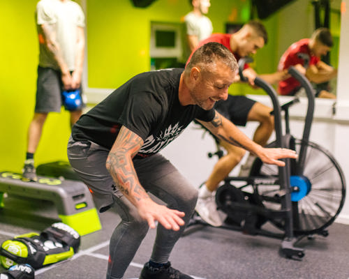 Man balancing on gym equipment in a gym setting