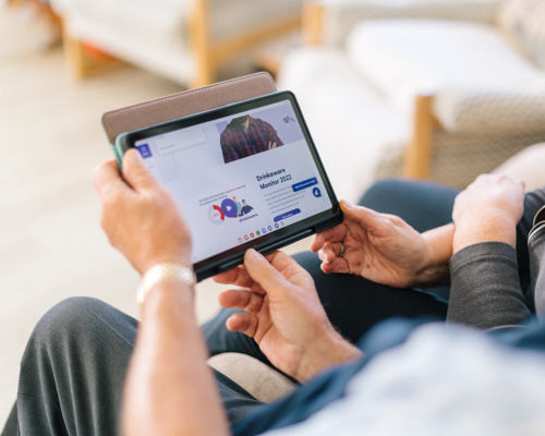 An older couple sitting in their living room looking at the Drinkaware website on a tablet