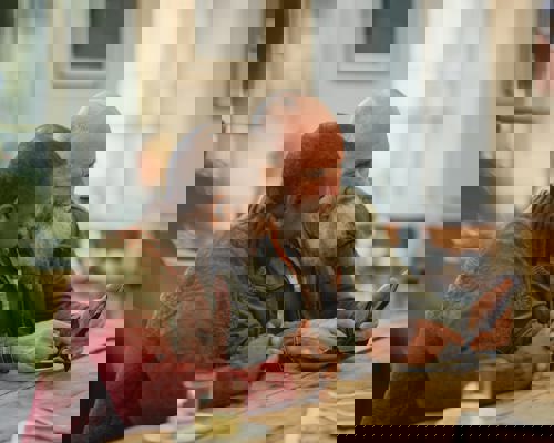 Men in cafe looking at phone
